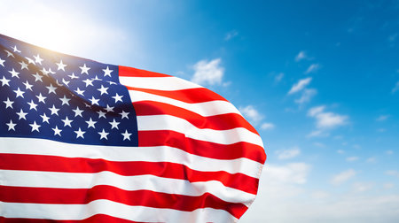 American flag waving on blue sky backgroundの写真素材