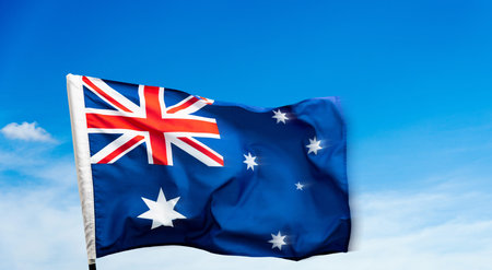 Australia flag waving on blue sky background