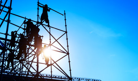 Group of construction workers working on scaffoldingの写真素材