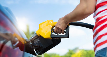 Woman hand refilling the car with fuelの写真素材