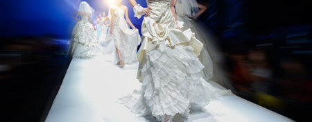 Wedding dress fashion show with models on the stageの写真素材