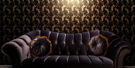 Single purple sofa with two cushions in front of beautiful wallpaperの写真素材
