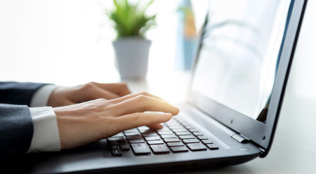 Closeup of businessman hands working on laptopの写真素材