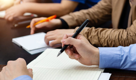 People hand writing at the conference
