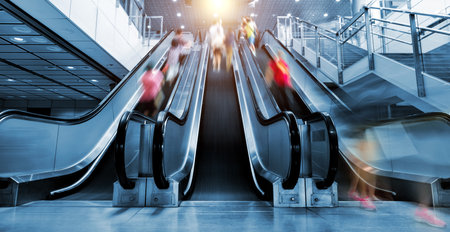 People rushing in the escalator lobbyの写真素材