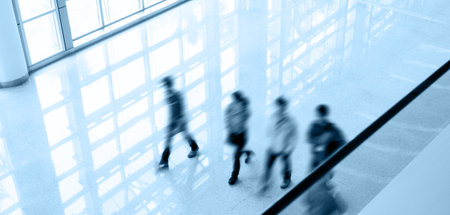 Group of business people walking in modern office buildingの写真素材