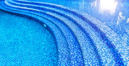 Steps in the swimming pool with blue ceramic tile mosaicの写真素材