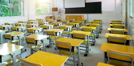 Empty classroom with desks and chairsの写真素材