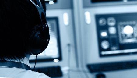 Rear view of flight controller working in the flight control towerの写真素材