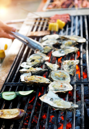 Group of fresh oyster on fireの写真素材