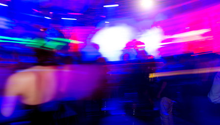 Abstract dancing people motion blur effect in nightclubの写真素材