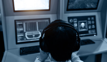 Rear view of flight controller working in the flight control tower