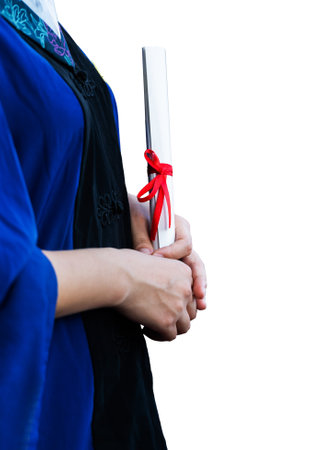 Female student in gown holding a diploma against white backgroundの写真素材