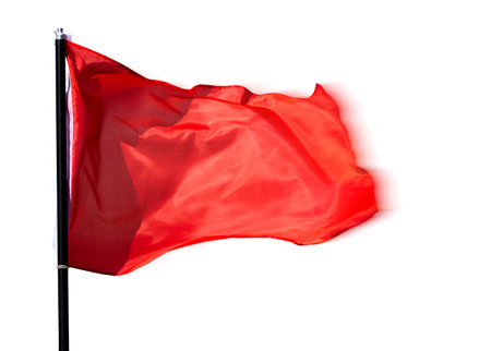 Red flag waving against white backgroundの写真素材