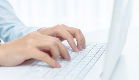 Closeup of woman hands working on laptopの写真素材