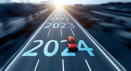 Blurred motion highway with red car, and new year number 2024, 2023 on the roadの写真素材