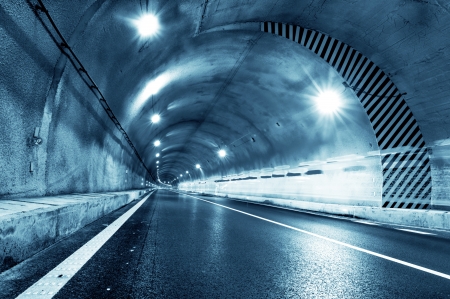 Abstract speed motion in urban highway road tunnel, blurred motion toward the central  Shot from a slow moving carの写真素材