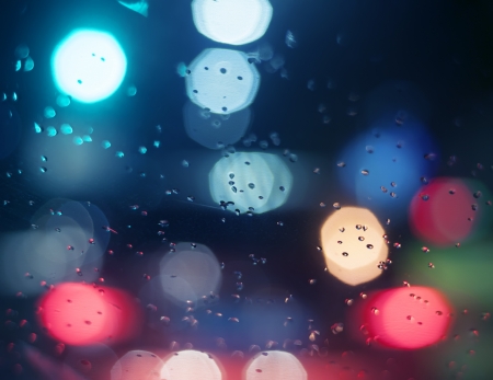 Wet the window with the background of the night city の写真素材