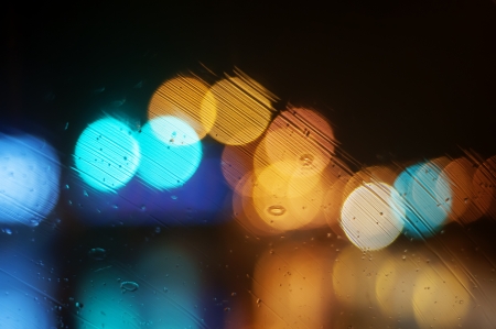 Wet the window with the background of the night city の写真素材