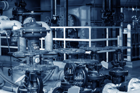 Closeup of manometer, pipes and faucet valves of heating system in a boiler room