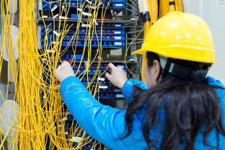 woman connecting network cables to switches