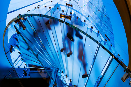 modern glass spiral staircase in shop with motion stepの写真素材