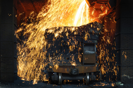 Liquid iron from ladle in the steelworksの写真素材