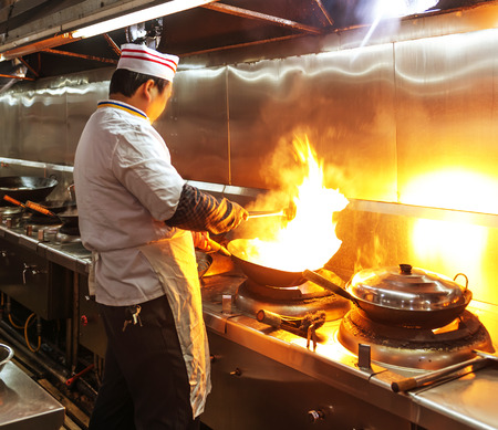 Crowded kitchen, a narrow aisle, working chef.の写真素材
