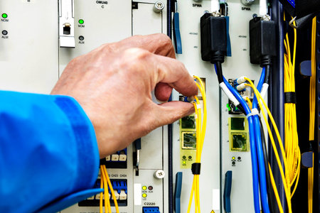 Man connecting network cables to switches