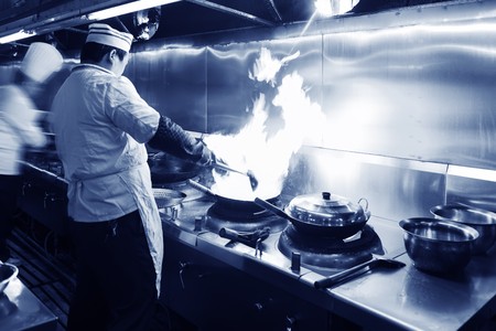 Crowded kitchen, a narrow aisle, working chef.の写真素材