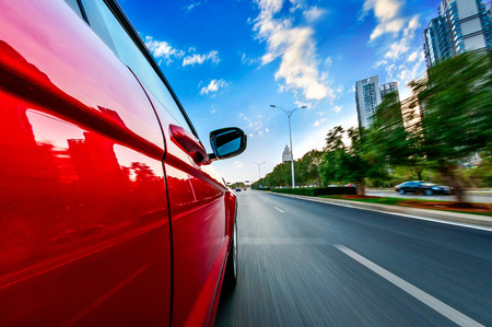A car driving on a motorway at high speeds, overtaking other carsの写真素材