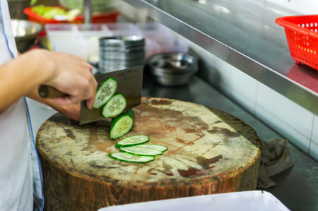 Chinese chef is cutting cucumberの写真素材