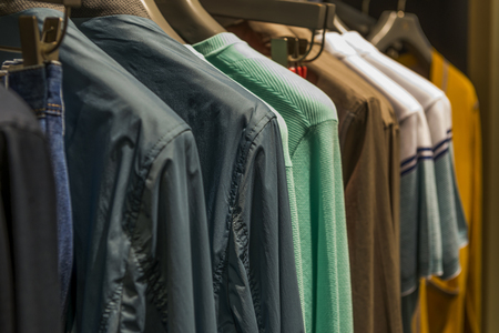 Row of men suit jackets on hangersの写真素材