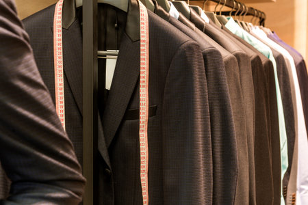 Row of men suit jackets on hangers