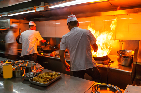 Crowded kitchen, a narrow aisle, working chef.の写真素材