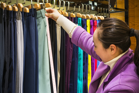 Colorful trousers, folded placed on Showcase.の写真素材