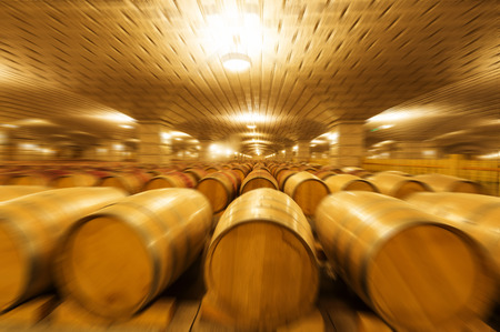 Wine barrels stacked in the cellar of the winery.の写真素材