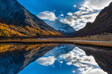 Beautiful golden Snow Mountain, Peak Jambeyang, Daocheng Yading National Park, Sichuan, China.