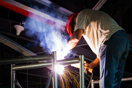 Metal grinding on steel pipe close up