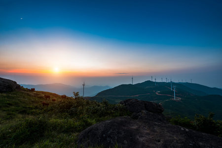Wind turbine against mountain