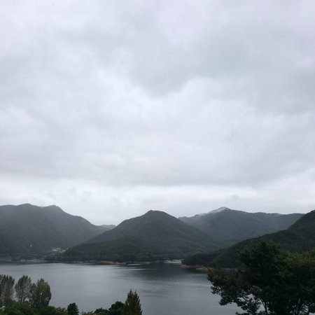 mountains and lake under cloudy skyの写真素材