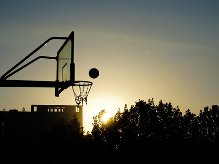 playing basketball while sunsetの写真素材
