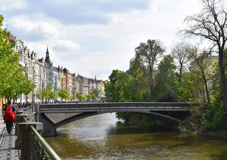 A little bridge on a river with colorful buildings in Prague city center, in Czech Republicのeditorial素材