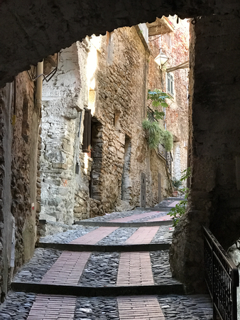 A small stone alley in the Medieval ancient hamlet of Dolceacqua in Italy.の写真素材