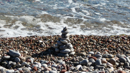 Many little pebbles near the limpid sea. Suitable to be used like a background.の写真素材