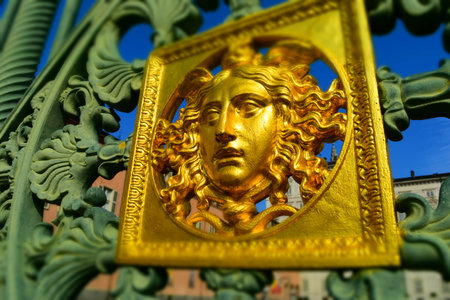 A golden face: detail of the original metal fence of the Royal Palace of Turin, Italy. Tilt-shift effect applied.のeditorial素材