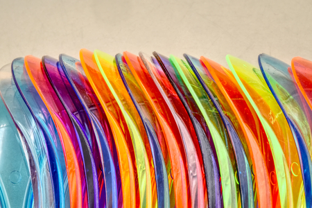 Many colorful plastic teaspoons disposable with copy space.の写真素材