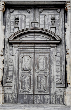 A big ancient Medieval grey wooden door.のeditorial素材