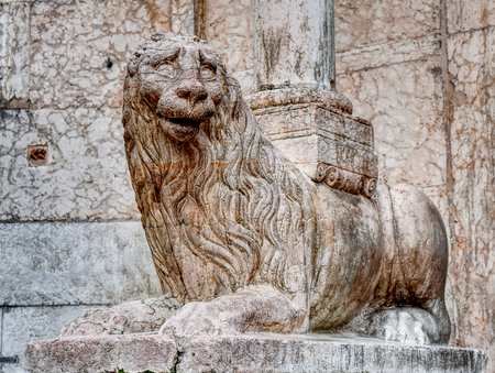 An ancient white marble statue of a monster similar to a lion with stone background.のeditorial素材