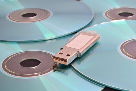 Many light blue cd and a pen drive.の写真素材
